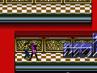 Catwoman knocks out a guard in the museum