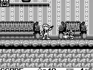 Dennis is shooting the cat with his squirt gun.