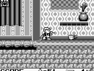 Dennis shots the cup with his blowpipe.