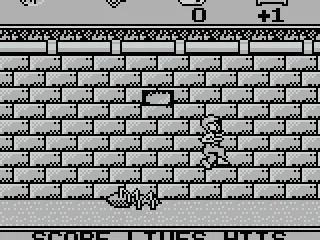 Jump at the brick so it falls on the spider