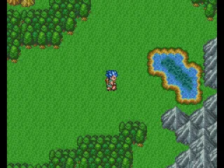 An open area with mountains and a lake