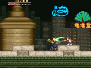 On a rooftop in front of a large city