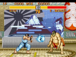 Ryu throws a Hadouken in direction to Honda, but what will do the Sumo fighter: jump or defend?